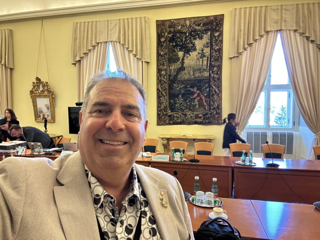 Adrian Cropley OAM, FRSA, FCSCE, IABC Fellow, SCMP, GCSCE, in a beautiful conference room